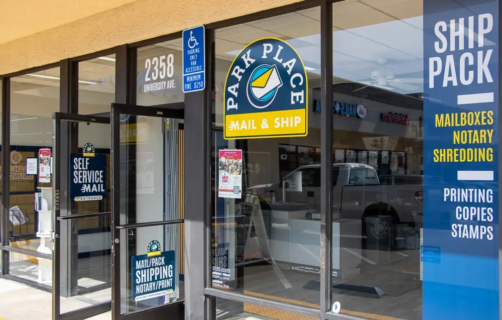 Entrance of a mail and shipping store with signage for services offered